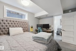 Recessed lighting, flush-mount ceiling light, window well, four-panel interior door, and light gray wall paint - 