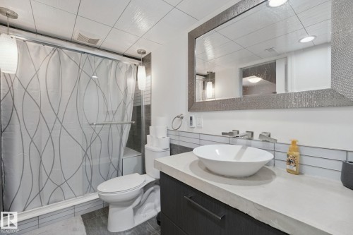 Recessed lighting illuminating a frameless shower with a built-in bench - 324 Ascott Crescent, Sherwood Park, AB 