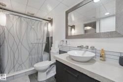 Recessed lighting illuminating a frameless shower with a built-in bench - 