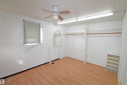 Wood-finish flooring, ceiling fan, built-in closet organization, and window with blinds - #16 4202 45 St, Wetaskiwin, AB 