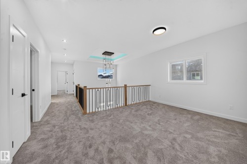 Carpeted hallway with white walls and recessed lighting - 13024 186 Avene Nw, Edmonton, AB 