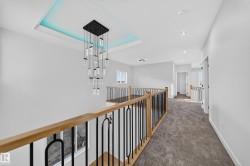 Modern chandelier with tray ceiling and accent lighting - 