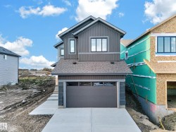 Modern exterior with vertical siding, attached garage, and concrete driveway - 
