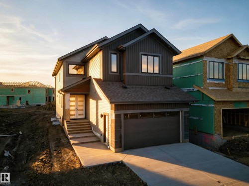 Contemporary exterior with multi-toned siding, attached garage, and a concrete driveway - 13024 186 Avene Nw, Edmonton, AB 