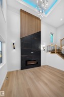 Soaring ceilings with a decorative light fixture and recessed lighting - 