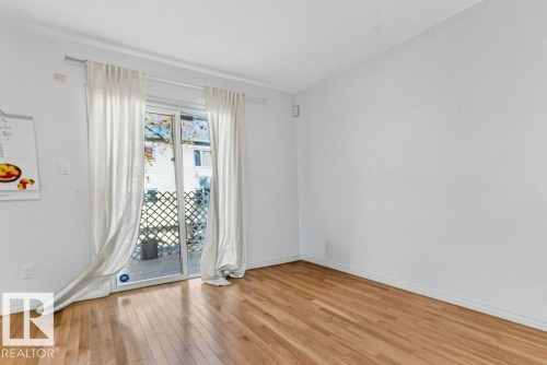 Hardwood flooring throughout, sliding glass door, and white wall finishes - Edmonton, AB 