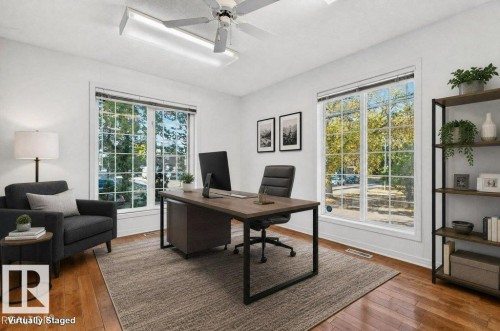 Bright home office with abundant natural light from multiple French doors and windows overlooking mature landscaping - Edmonton, AB 