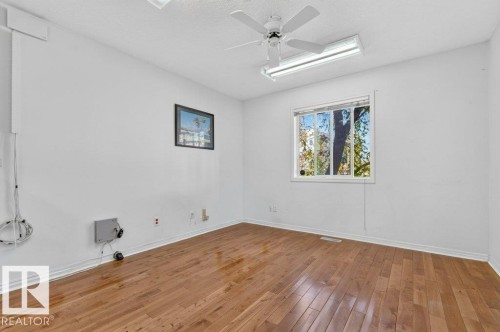 Hardwood flooring, white walls, white trim, white ceiling fan, and recessed lighting - Edmonton, AB 
