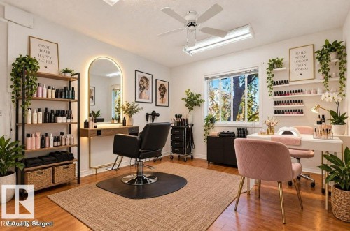 Hardwood-finish flooring featuring a large window, ceiling fan, recessed lighting, and wall-mounted shelving - Edmonton, AB 