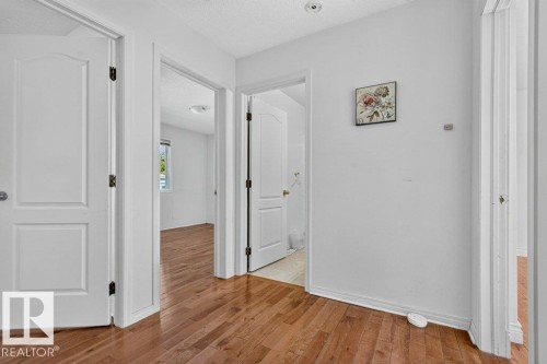 Hardwood flooring throughout, white interior doors, and recessed ceiling lighting - Edmonton, AB 