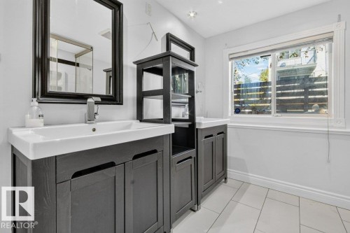 Dual vanity sinks with dark wood-finish cabinetry - Edmonton, AB 