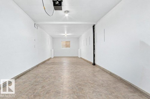 Spacious room featuring tiled flooring, recessed lighting, and a window - Edmonton, AB 