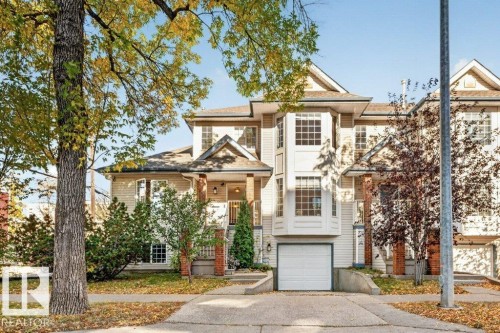 Multi-level residence featuring a single-car garage, bay windows, and a covered entry - Edmonton, AB 
