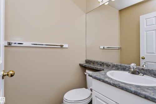Vanity with integrated sink, patterned countertop, and chrome faucet - 4112 37A Avenue Nw, Edmonton, AB 