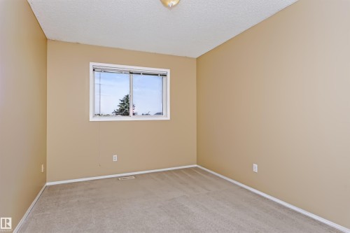 Neutral-toned walls complement plush carpeting - 4112 37A Avenue Nw, Edmonton, AB 