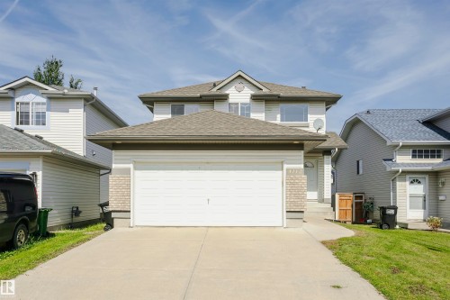 Two-story residence featuring light-colored siding and a multi-level roofline - 4112 37A Avenue Nw, Edmonton, AB 
