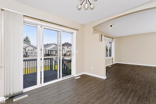 Hard-surface flooring extending into an open concept layout with an arched entry - 4112 37A Avenue Nw, Edmonton, AB 