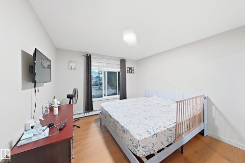 Bright room featuring light-colored walls and wood-finish flooring - #116 4008 Savaryn Dr Sw Sw, Edmonton, AB 