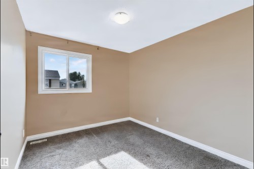 Neutral wall color, white trim, white ceiling, flush-mount ceiling light, and window with white frame - 155 Primrose Gardens Gardens Nw, Edmonton, AB 