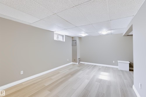 Recessed lighting with white diffusers, light wood-finish flooring, and neutral wall paint - 155 Primrose Gardens Gardens Nw, Edmonton, AB 