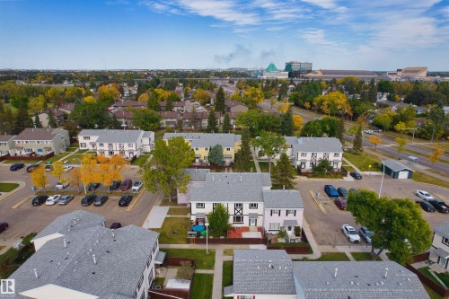 Townhouse community with multiple units, paved parking areas, and mature trees - 155 Primrose Gardens Gardens Nw, Edmonton, AB 