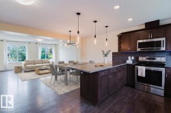 Open-concept living space featuring dark wood-finish flooring - 