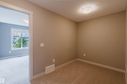 Compact room featuring neutral-toned walls, contrasting white baseboards, and a flush-mount ceiling light - 