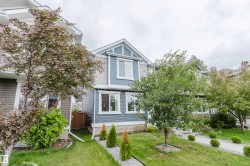 Two-story residence featuring light blue and gray siding with white trim - 