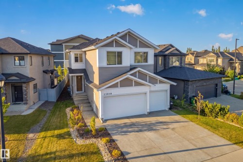 Two-story residence featuring a two-car garage, concrete driveway, and front landscaping - 11010 174A Avenue Nw, Edmonton, AB 