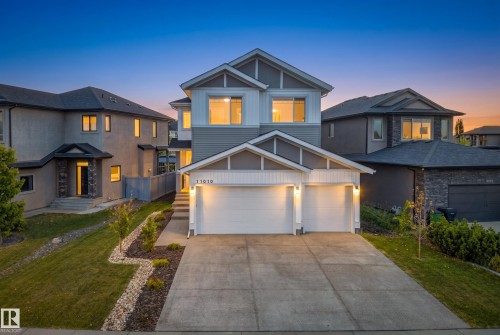 Contemporary exterior with light gray siding, white trim, and a two-car garage - 11010 174A Avenue Nw, Edmonton, AB 