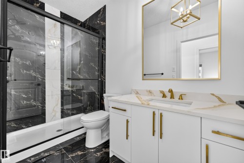 Vanity with a gold-framed mirror and a gold-finish chandelier - 11010 174A Avenue Nw, Edmonton, AB 