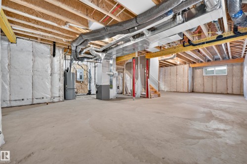 Expansive unfinished basement featuring exposed ceiling joists, concrete flooring, insulated exterior walls, and a window for natural light - 11010 174A Avenue Nw, Edmonton, AB 