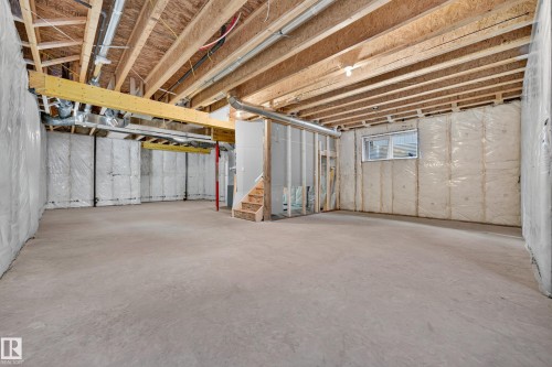 Unfinished basement space with exposed wood joists and subfloor, concrete flooring, and partial wall insulation - 11010 174A Avenue Nw, Edmonton, AB 