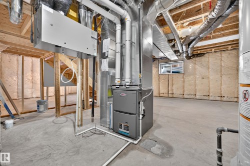 Unfinished basement with concrete flooring, exposed wood framing, and visible insulation - 11010 174A Avenue Nw, Edmonton, AB 
