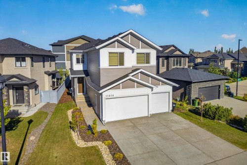 Contemporary exterior with a two-car attached garage, paved driveway, and landscaped front yard - 11010 174A Avenue Nw, Edmonton, AB 