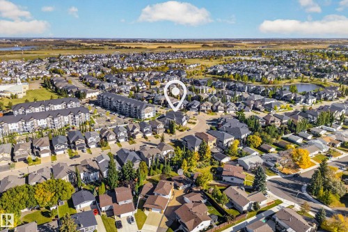 Residential neighborhood with varied architectural styles, mature trees, and a visible water feature - 11010 174A Avenue Nw, Edmonton, AB 