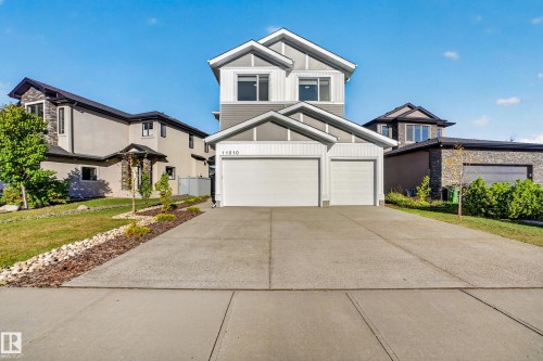 Contemporary two-story exterior with a two-car garage, concrete driveway, and front landscaping - 11010 174A Avenue Nw, Edmonton, AB 
