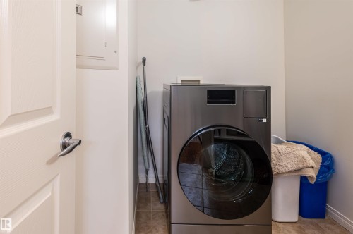 Front-loading laundry machine with a dark finish - #230 45 Inglewood Dr, St. Albert, AB 