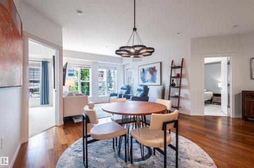 Hardwood flooring, contemporary chandelier, multiple windows, white interior walls, white trim - #230 45 Inglewood Dr, St. Albert, AB 
