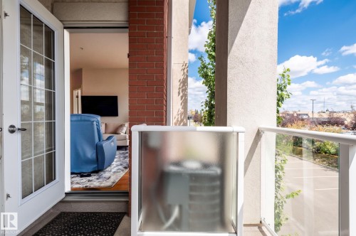 Private balcony with glass panel railing and painted stucco exterior - #230 45 Inglewood Dr, St. Albert, AB 