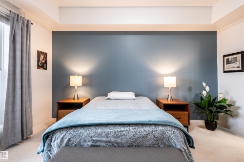 Recessed ceiling feature, window with drapes, accent wall, two wood-finish nightstands, wall-to-wall carpeting - #230 45 Inglewood Dr, St. Albert, AB 