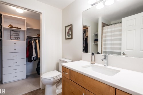 Bathroom featuring a wood-finish vanity, white countertop, rectangular undermount sink, and polished chrome faucet - #230 45 Inglewood Dr, St. Albert, AB 