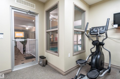 Carpeted fitness area with an elliptical machine - #230 45 Inglewood Dr, St. Albert, AB 