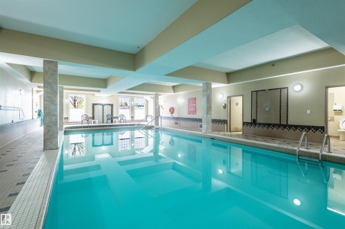 Indoor swimming pool featuring metal access ladders and tiled surround - #230 45 Inglewood Dr, St. Albert, AB 