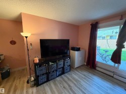 Wood-finish flooring with a sliding glass door and wall-mounted heating unit - 