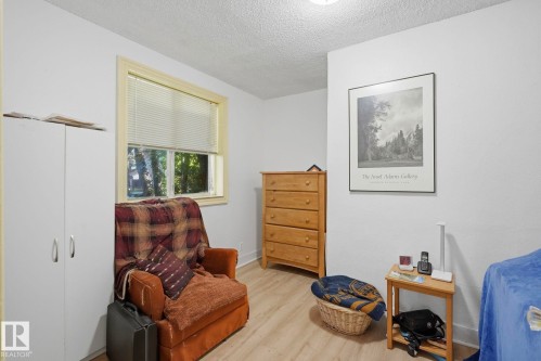 Wood-finish flooring with white walls and a textured ceiling - 9628 100A Street Nw, Edmonton, AB 