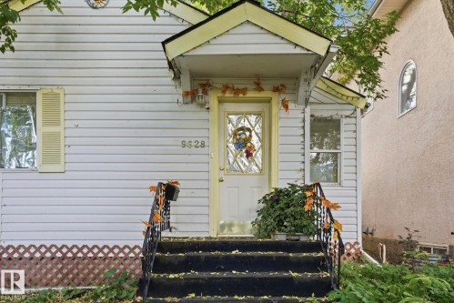 White horizontal siding exterior with a front entry porch - 9628 100A Street Nw, Edmonton, AB 