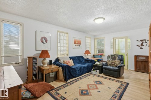 White walls with a textured ceiling and a flush-mount overhead light - 9628 100A Street Nw, Edmonton, AB 