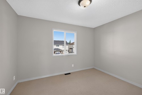 Light gray painted walls, a single window, and carpeted flooring - 6116 8 Avenue Sw, Edmonton, AB 