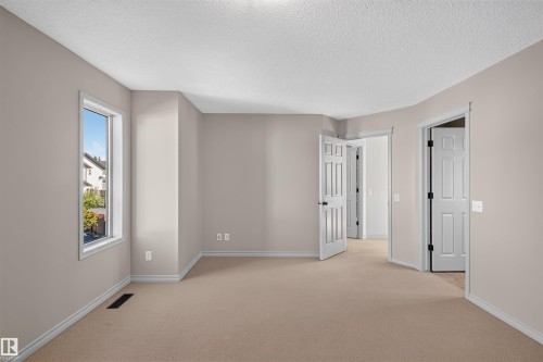 Carpeted flooring, neutral wall tones, white trim, and white paneled doors - 6116 8 Avenue Sw, Edmonton, AB 